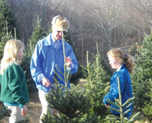 Sam teaching his granddaughters to top trees